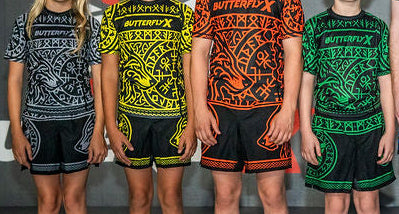 Group of people wearing colorful athletic outfits in front of a branded backdrop